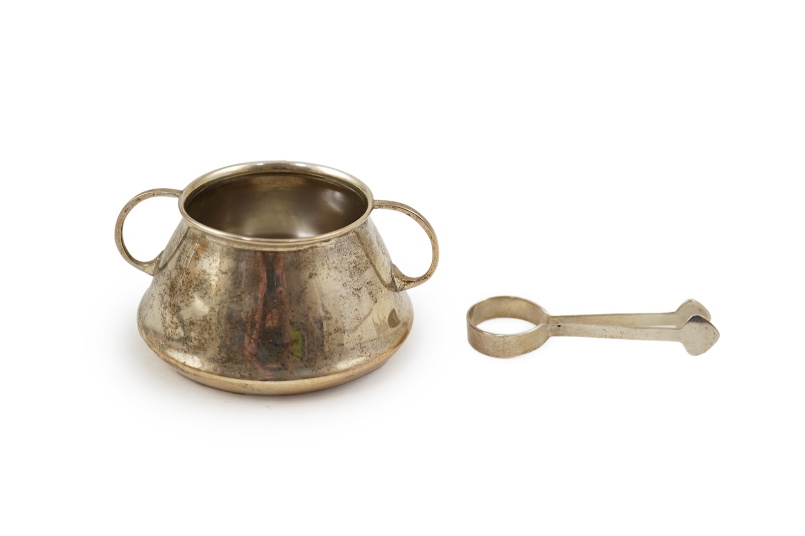 An Edwardian silver bachelor's two handled sugar bowl and matching sugar tongs, by Liberty & Co